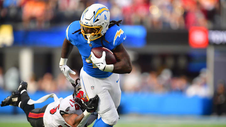 Dec 15, 2024; Inglewood, California, USA; Los Angeles Chargers running back Gus Edwards (4) runs the ball against the against the Tampa Bay Buccaneers during the first half at SoFi Stadium. Mandatory Credit: Gary A. Vasquez-Imagn Images Dec 15, 2024; Inglewood, California, USA; Los Angeles Chargers running back Gus Edwards (4) runs the ball against the against the Tampa Bay Buccaneers during the first half at SoFi Stadium. Mandatory Credit: Gary A. Vasquez-Imagn Images