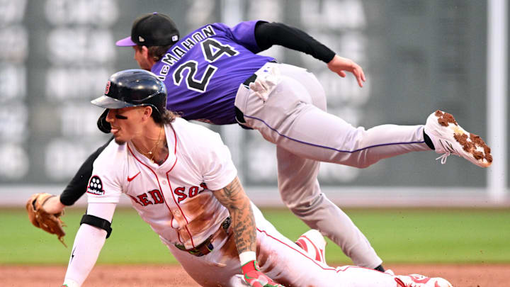 Jul 9, 2025; Boston, Massachusetts, USA; Boston Red Sox outfielder Jarren Duran (16) slides safely into third base ahead of a tag by Colorado Rockies third base Ryan McMahon (24) during the first inning at Fenway Park. 
