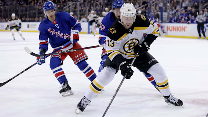 Feb 5, 2025; New York, New York, USA; Boston Bruins center Charlie Coyle (13) controls the puck against New York Rangers left wing Artemi Panarin (10) and center Mika Zibanejad (93) during the first period at Madison Square Garden. Mandatory Credit: Brad Penner-Imagn Images