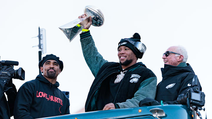 Feb 14, 2025; Philadelphia, PA, USA; Philadelphia Eagles running back Saquon Barkley (26) lifts the Lombardi Trophy during the Super Bowl LIX championship parade and rally. Mandatory Credit: Caean Couto-Imagn Images
