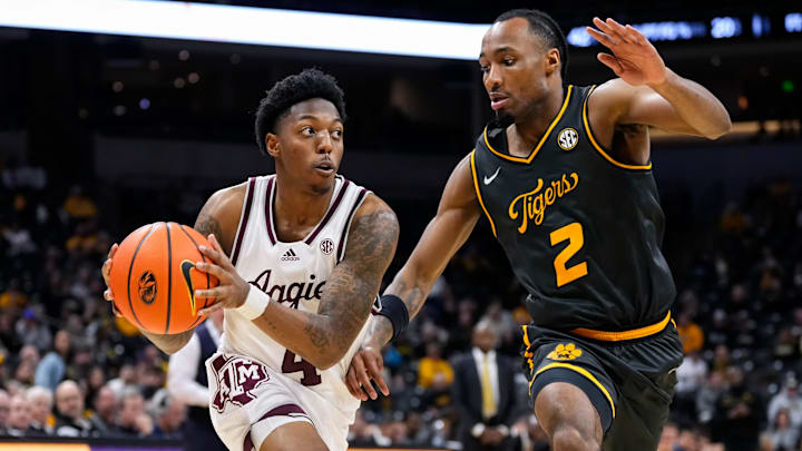 Feb 7, 2024; Columbia, Missouri, USA; Texas A&M Aggies guard Wade Taylor IV (4) drives against Missouri Tigers guard Tamar Bates (2) during the second half at Mizzou Arena. Mandatory Credit: Jay Biggerstaff-Imagn Images