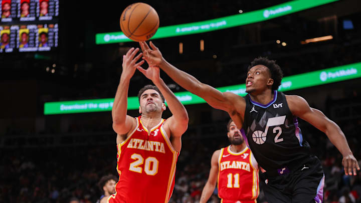 Atlanta Hawks forward Georges Niang (20) and Utah Jazz guard Collin Sexton (2) reach for a loose ball in the third quarter at State Farm Arena.