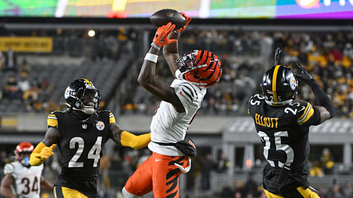 Jan 4, 2025; Pittsburgh, Pennsylvania, USA; Cincinnati Bengals wide receiver Tee Higgins (5) catches a pass in front of Pittsburgh Steelers cornerback Joey Porter Jr. (24) and safety DeShon Elliott (25) during the second quarter at Acrisure Stadium.  