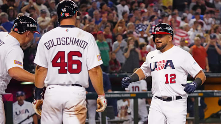 USA designated hitter Kyle Schwarber (12) celebrates with Mike Trout (L) and Paul Goldschmidt (46) after hitting a three-run home run against Great Britain during the World Baseball Classic at Chase Field in Phoenix on March 11, 2023.
