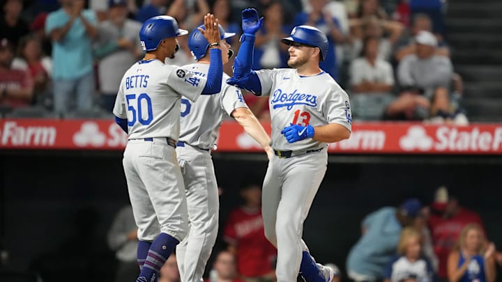 Aug 11, 2025; Anaheim, California, USA; Los Angeles Dodgers third baseman Max Muncy (13) celebrates with shortstop Mookie Betts (50) after hitting a three-run home run in the eighth inning against the Los Angeles Angels at Angel Stadium. Mandatory Credit: Kirby Lee-Imagn Images