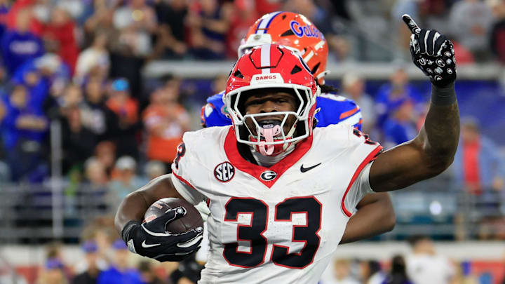 Georgia Bulldogs running back Chauncey Bowens (33) helps pull the Bulldogs ahead on a touchdown score during the fourth quarter of an NCAA football game, Saturday, Nov. 1, 2025, at EverBank Stadium in Jacksonville, Fla. Georgia held off Florida 24-20. [Corey Perrine/Florida Times-Union]