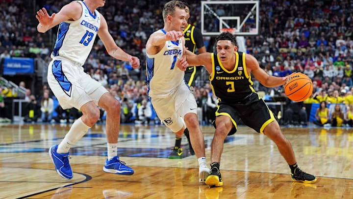 Oregon Ducks guard Jackson Shelstad (3) drives to the basket against Creighton Bluejays guard Steven Ashworth (1) and forward Mason Miller (13) during the first half in the second round of the 2024 NCAA Tournament at PPG Paints Arena.