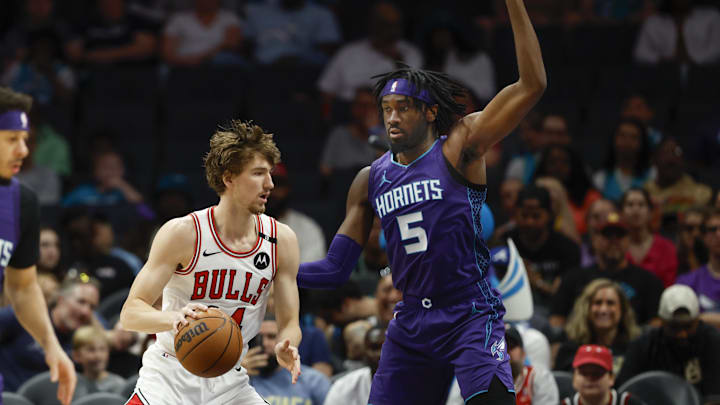 Apr 6, 2025; Charlotte, North Carolina, USA; Chicago Bulls forward Matas Buzelis (14) drives against Charlotte Hornets center Mark Williams (5) during the first quarter at Spectrum Center. Mandatory Credit: Nell Redmond-Imagn Images