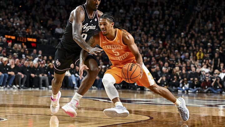Feb 22, 2025; College Station, Texas, USA; Tennessee Volunteers guard Zakai Zeigler (5) drives to the basket as Texas A&M Aggies forward Solomon Washington (9) defends during the second half at Reed Arena. Mandatory Credit: Maria Lysaker-Imagn Images 