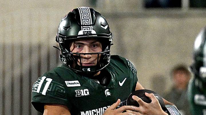 Sep 26, 2026; East Lansing, Michigan, USA;  Michigan State Spartans quarterback Alessio Milivojevic (11) looks for a block upfield as he sprints around the left side of the line against the Nebraska Cornhuskers at Spartan Stadium.  Mandatory Credit: Dale Young-Imagn Images