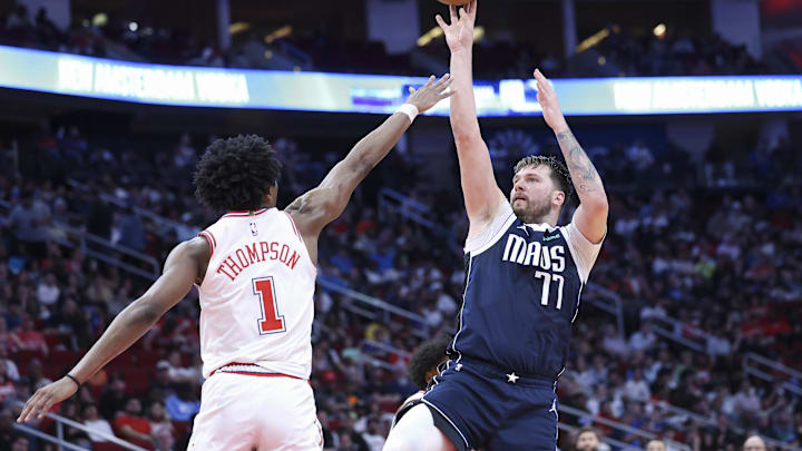 Mar 31, 2024; Houston, Texas, USA; Dallas Mavericks guard Luka Doncic (77) shoots the ball as Houston Rockets forward Amen Thompson (1) defends during the third quarter at Toyota Center. Mandatory Credit: Troy Taormina-Imagn Images Mar 31, 2024; Houston, Texas, USA; Dallas Mavericks guard Luka Doncic (77) shoots the ball as Houston Rockets forward Amen Thompson (1) defends during the third quarter at Toyota Center. Mandatory Credit: Troy Taormina-Imagn Images
