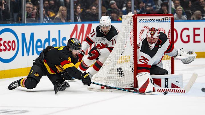 New Jersey Devils defenseman Jonas Siegenthaler (71) watches as goalie Jacob Markstrom (25) makes a save: Bob Frid-Imagn Images