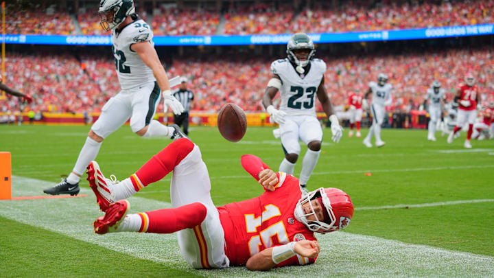 Sep 14, 2025; Kansas City, Missouri, USA; Kansas City Chiefs quarterback Patrick Mahomes (15) scores a touchdown defended by Philadelphia Eagles defensive end Za'Darius Smith (52) and cornerback Jakorian Bennett (23) during the second quarter of the game at GEHA Field at Arrowhead Stadium. Mandatory Credit: Jay Biggerstaff-Imagn Images