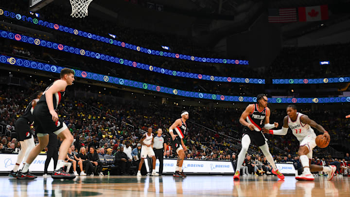 Oct 11, 2024; Seattle, Washington, USA; Los Angeles Clippers guard Kevin Porter Jr. (77) dribbles the ball while guarded by Portland Trail Blazers guard Dalano Banton (5) during the first half at Climate Pledge Arena. Mandatory Credit: Steven Bisig-Imagn Images