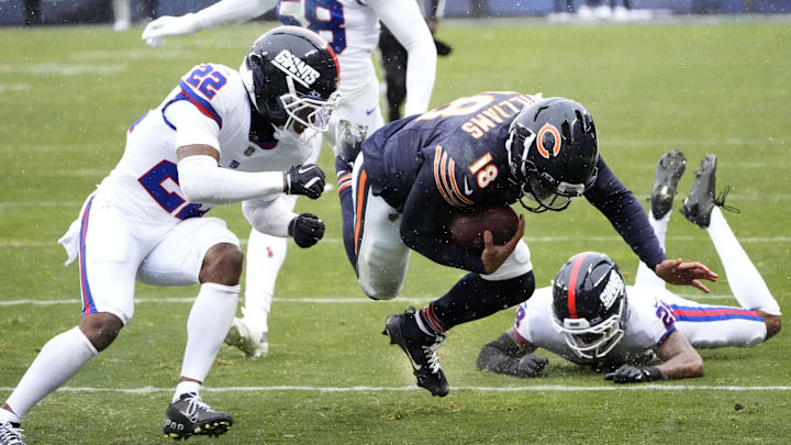 Nov 9, 2025; Chicago, Illinois, USA; Chicago Bears quarterback Caleb Williams (18) runs against New York Giants cornerback Dru Phillips (22), linebacker Bobby Okereke (58) and cornerback Cor'Dale Flott (28) during the second half at Soldier Field. Mandatory Credit: David Banks-Imagn Images Nov 9, 2025; Chicago, Illinois, USA; Chicago Bears quarterback Caleb Williams (18) runs against New York Giants cornerback Dru Phillips (22), linebacker Bobby Okereke (58) and cornerback Cor'Dale Flott (28) during the second half at Soldier Field. Mandatory Credit: David Banks-Imagn Images