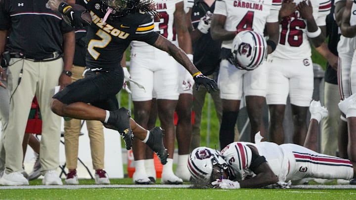 Sep 20, 2025; Columbia, Missouri, USA; Missouri Tigers wide receiver Marquis Johnson (2) runs the ball as South Carolina Gamecocks defensive back Myles Norwood (3) misses a tackle during the first half of the game at Faurot Field at Memorial Stadium. Mandatory Credit: Denny Medley-Imagn Images Sep 20, 2025; Columbia, Missouri, USA; Missouri Tigers wide receiver Marquis Johnson (2) runs the ball as South Carolina Gamecocks defensive back Myles Norwood (3) misses a tackle during the first half of the game at Faurot Field at Memorial Stadium. Mandatory Credit: Denny Medley-Imagn Images