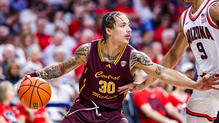 Dec 21, 2024; Tucson, Arizona, USA; Central Michigan Chippewas guard Anthony Pritchard (30) dribbles the ball while Arizona Wildcats forward Carter Bryant (9) attempts to block him during the second half of the game at McKale Center. Dec 21, 2024; Tucson, Arizona, USA; Central Michigan Chippewas guard Anthony Pritchard (30) dribbles the ball while Arizona Wildcats forward Carter Bryant (9) attempts to block him during the second half of the game at McKale Center.
