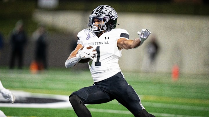 Ankeny Centennial's Braeden Jackson (1) jukes defenders as he runs the ball downfield on Friday, Nov. 8, 2024, at Mediacom Stadium.