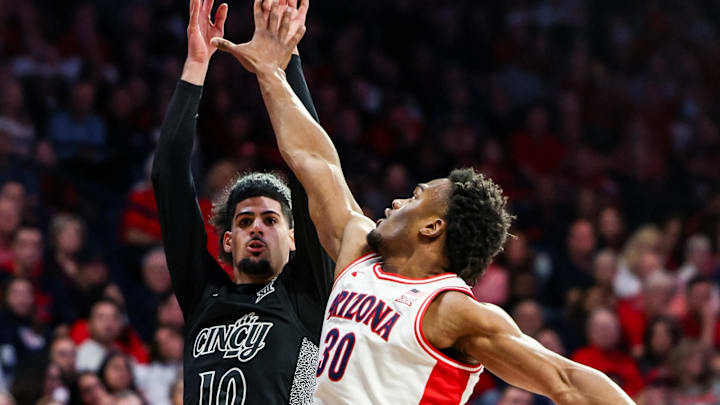 Jan 21, 2026; Tucson, Arizona, USA; Arizona Wildcats forward Tobe Awaka (30) fouls Cincinnati Bearcats guard Shon Abaev (10) during the first half of the game at McKale Memorial Center. Mandatory Credit: Aryanna Frank-Imagn Images