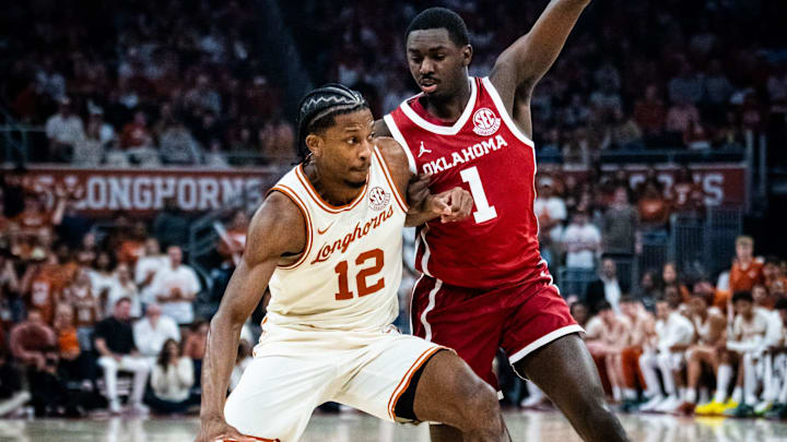 Texas Longhorns guard Tramon Mark (12) protects the ball from Oklahoma Sooners guard Kobe Elvis (1)