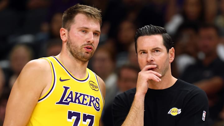 Oct 14, 2025; Phoenix, Arizona, USA; Los Angeles Lakers guard Luka Doncic (77) with head coach JJ Redick against the Phoenix Suns during an NBA preseason game at Mortgage Matchup Center. Mandatory Credit: Mark J. Rebilas-Imagn Images

