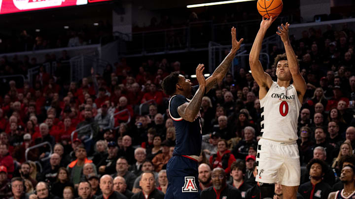 Cincinnati Bearcats guard Dan Skillings Jr. (0) hits a 3-point basket over Arizona Wildcats guard Anthony Dell'Orso (3) in the first half of the NCAA basketball game at the Fifth Third Arena in Cincinnati on Saturday, January 4, 2025. Cincinnati Bearcats guard Dan Skillings Jr. (0) hits a 3-point basket over Arizona Wildcats guard Anthony Dell'Orso (3) in the first half of the NCAA basketball game at the Fifth Third Arena in Cincinnati on Saturday, January 4, 2025.