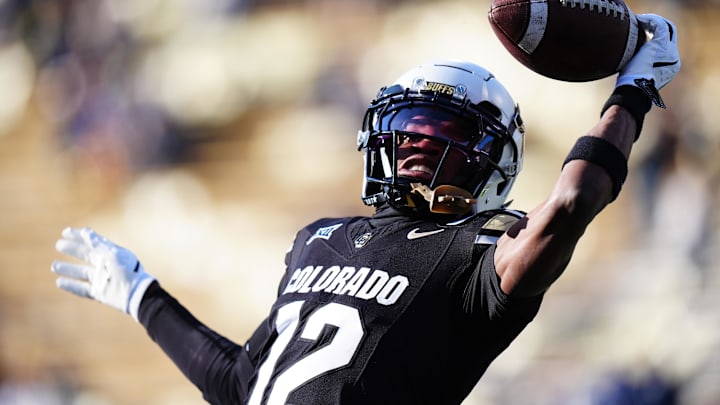 Nov 29, 2024; Boulder, Colorado, USA; Colorado Buffaloes wide receiver Travis Hunter (12) warms up before the game against the Oklahoma State Cowboys at Folsom Field. Mandatory Credit: Ron Chenoy-Imagn Images