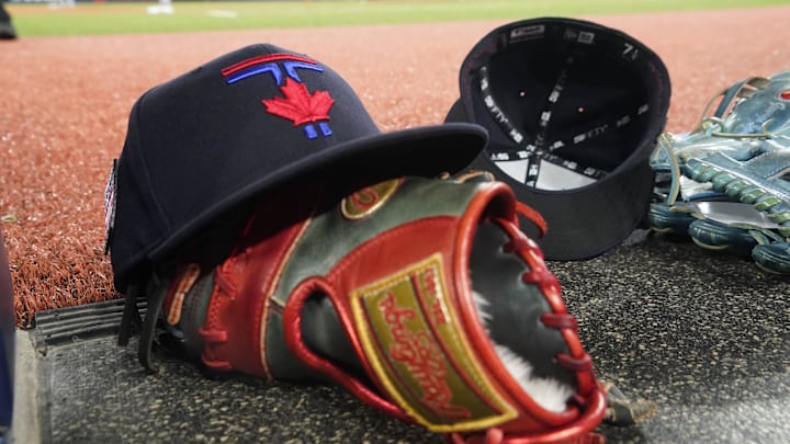 Jul 19, 2024; Toronto, Ontario, CAN; A Toronto Blue Jays hat and glove near the dugout during a game against the Detroit Tigers at Rogers Centre. Mandatory Credit: John E. Sokolowski-Imagn Images Jul 19, 2024; Toronto, Ontario, CAN; A Toronto Blue Jays hat and glove near the dugout during a game against the Detroit Tigers at Rogers Centre. Mandatory Credit: John E. Sokolowski-Imagn Images