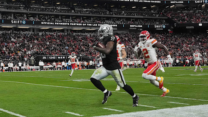 Nov 26, 2023; Paradise, Nevada, USA; Las Vegas Raiders running back Josh Jacobs (8) is pursued by Kansas City Chiefs cornerback Joshua Williams (2) on a 63-yard touchdown run in the first half at Allegiant Stadium. Mandatory Credit: Kirby Lee-Imagn Images