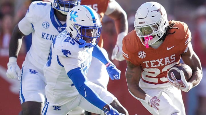 Texas Longhorns running back Jaydon Blue looks for room to run against Kentucky Wildcats defensive back Jordan Lovett in the first quarter of an NCAA college football game.