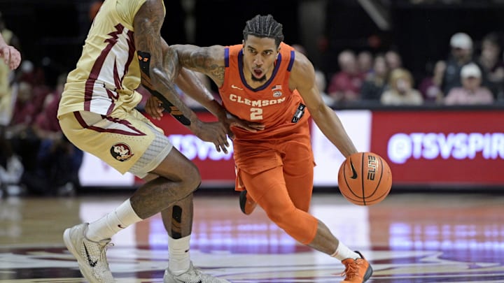Feb 15, 2025; Tallahassee, Florida, USA; Clemson Tigers guard Dillon Hunter (2) drives up the court against Florida State Seminoles forward Jamir Watkins (1) during the second half at Donald L. Tucker Center. Mandatory Credit: Melina Myers-Imagn Images