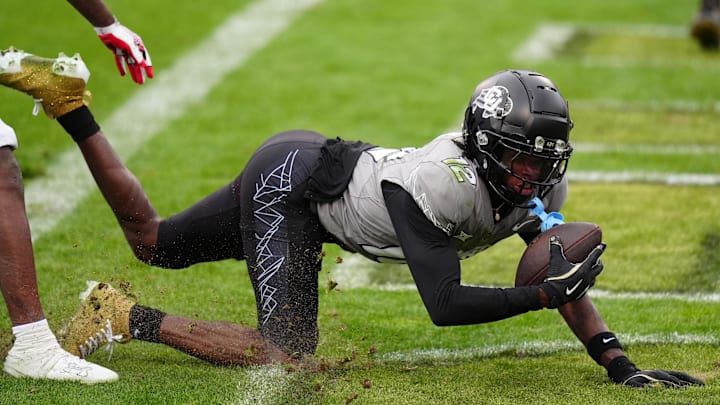 Nov 16, 2024; Boulder, Colorado, USA; Colorado Buffaloes wide receiver Travis Hunter (12) scores a touchdown in the fourth quarter against the Utah Utes at Folsom Field. Mandatory Credit: Ron Chenoy-Imagn Images