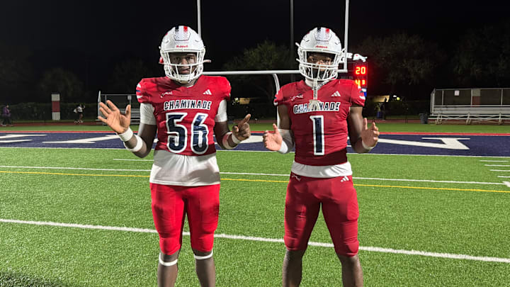 Chaminade-Madonna standouts RJ Alphonse (56) and Derrek Cooper (1) after the Lions roar past Miami Norland, 45-20.