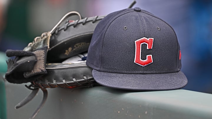 Jun 27, 2024; Kansas City, Missouri, USA; A general view a Cleveland Guardians hat and glove on the dugout railing before a game against the Kansas City Royals at Kauffman Stadium. Jun 27, 2024; Kansas City, Missouri, USA; A general view a Cleveland Guardians hat and glove on the dugout railing before a game against the Kansas City Royals at Kauffman Stadium.