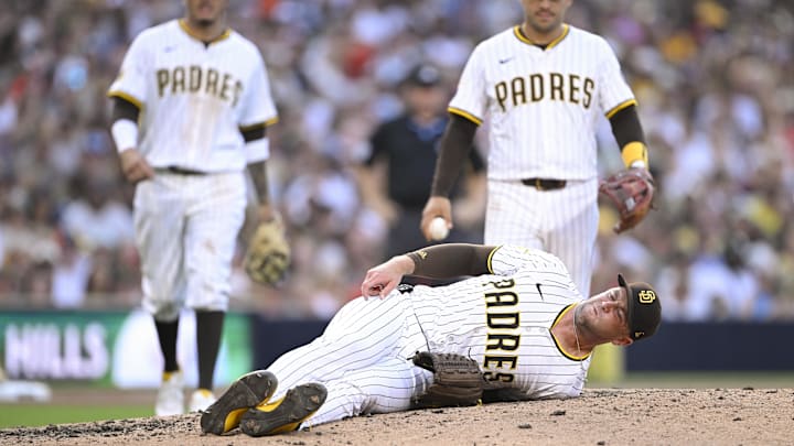Sep 1, 2025; San Diego, California, USA; San Diego Padres relief pitcher Jason Adam (40) lies on the ground during the seventh inning against the Baltimore Orioles at Petco Park. Adam was taken away in a cart after the play. Mandatory Credit: Denis Poroy-Imagn Images