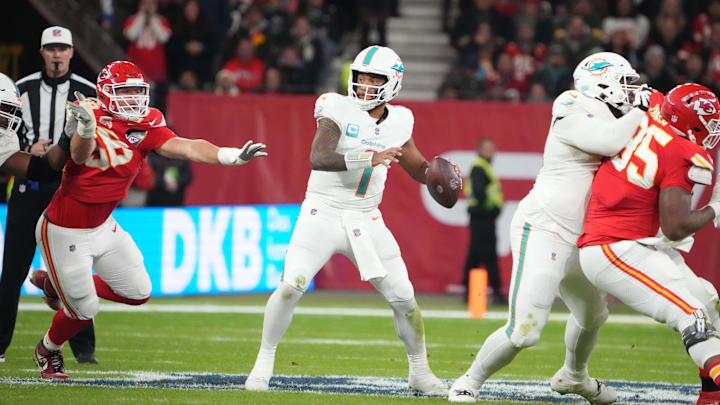 Miami Dolphins quarterback Tua Tagovailoa (1) throws the ball under pressure from Kansas City Chiefs defensive end George Karlaftis (56) in the second half during an NFL International Series game at Deutsche Bank Park in Germany in 2023.