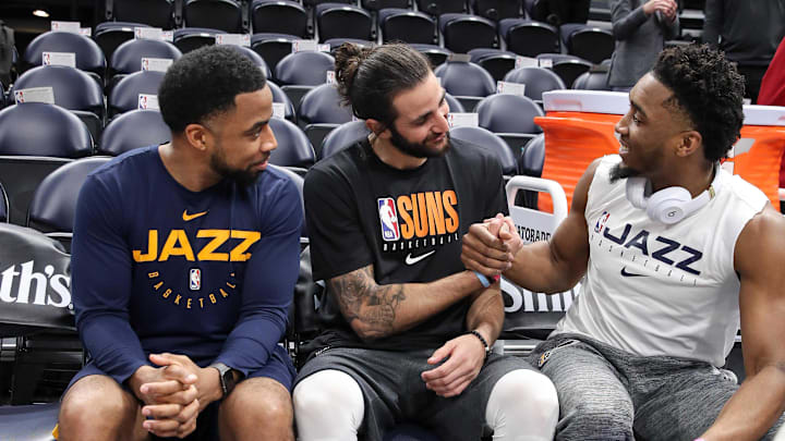Feb 24, 2020; Salt Lake City, Utah, USA; Phoenix Suns guard Ricky Rubio (11) and Utah Jazz guard Donovan Mitchell (45) talk before the game with assistant coach Johnnie Bryant at Vivint Smart Home Arena. Mandatory Credit: Chris Nicoll-Imagn Images