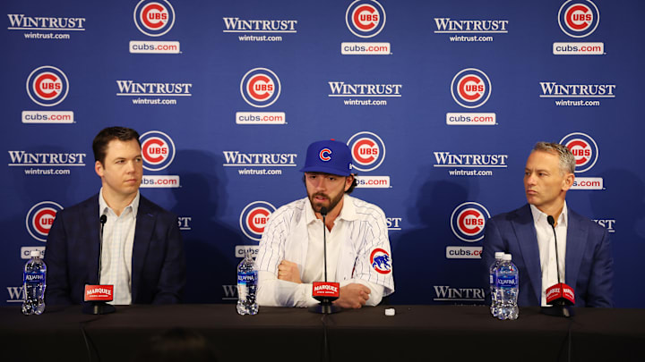 Chicago Cubs general manager Carter Hawkins and President of Baseball Operations Jed Hoyer sit beside Dansby Swanson.