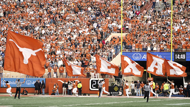 Texas Longhorns cheerleaders carry flags on the field after a touchdown during the first half against the Vanderbilt Commodores at Darrell K Royal-Texas Memorial Stadium. 
