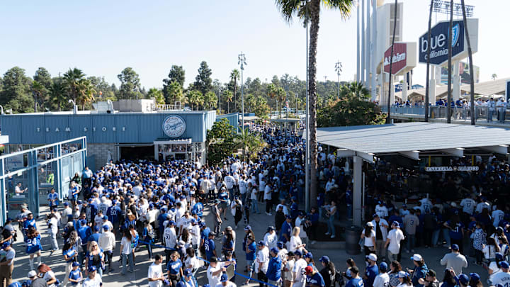 Fans arrive at Dodger Stadium to celebrate the World Series Champions, the Los Angeles Dodgers, on Nov. 1, 2024. Team stores around the stadium have deep lines of fans waiting to purchase World Series merchandise.