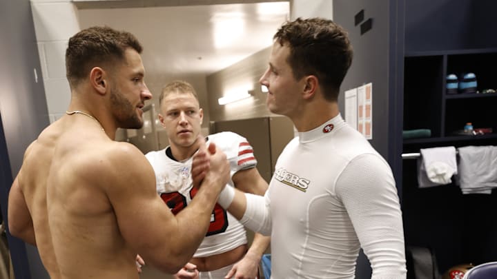 San Francisco 49ers edge Nick Bosa (L), running back Christian McCaffrey (C) and quarterback Brock Purdy (R)