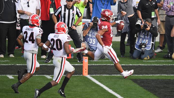 Oklahoma Sooners running back Rodney Anderson (24) scores ahead of Georgia Bulldogs safety Dominick Sanders (24) and defensive back J.R. Reed (20) during the second quarter of the 2018 Rose Bowl. Oklahoma Sooners running back Rodney Anderson (24) scores ahead of Georgia Bulldogs safety Dominick Sanders (24) and defensive back J.R. Reed (20) during the second quarter of the 2018 Rose Bowl.
