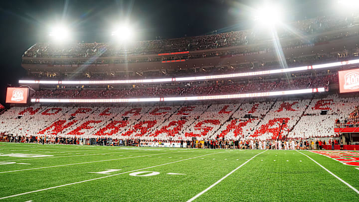 Sep 20, 2024; Lincoln, Nebraska, USA; Fans hold cards to commemorate the 400th consecutive sellout after the first quarter between the Nebraska Cornhuskers and the Illinois Fighting Illini at Memorial Stadium. 