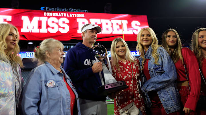 Lane Kiffin, center left, poses with the Ash Verlander Champions Trophy with his family after the game of the TaxSlayer Gator Bowl. Lane Kiffin, center left, poses with the Ash Verlander Champions Trophy with his family after the game of the TaxSlayer Gator Bowl.