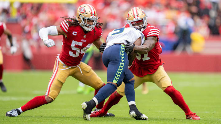 September 18, 2022; Santa Clara, California, USA; San Francisco 49ers linebacker Fred Warner (54) and linebacker Dre Greenlaw (57) tackle Seattle Seahawks running back Kenneth Walker III (9) during the third quarter at Levi's Stadium. Mandatory Credit: Kyle Terada-Imagn Images