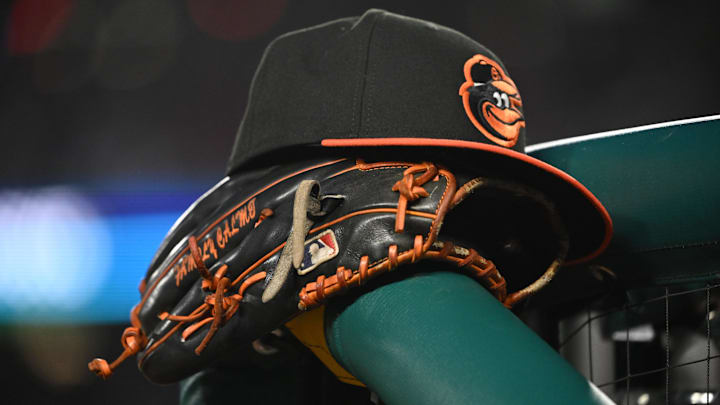 May 8, 2024; Washington, District of Columbia, USA; A Baltimore Orioles hat and glove rest on the dugout rail during a game against the Washington Nationals at Nationals Park. Mandatory Credit: Rafael Suanes-Imagn Images May 8, 2024; Washington, District of Columbia, USA; A Baltimore Orioles hat and glove rest on the dugout rail during a game against the Washington Nationals at Nationals Park. Mandatory Credit: Rafael Suanes-Imagn Images