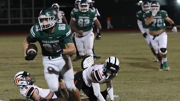 Flagler Palm Coast's Roman Caliendo (81) breaks free from a couple of Spruce Creek defenders during the Region 1-7A quarterfinals, Friday, Nov. 15, 2024.