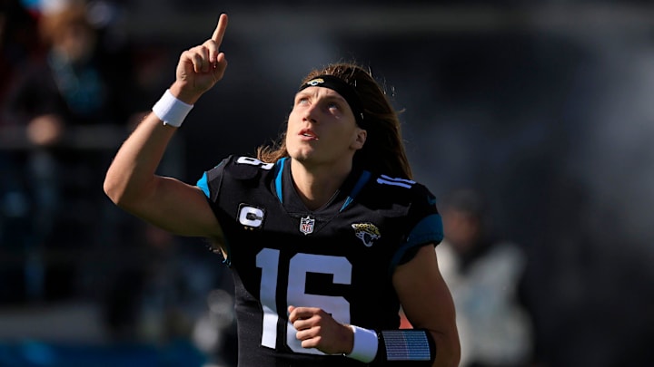 Jacksonville Jaguars quarterback Trevor Lawrence (16) takes to the field pointing skyward. 