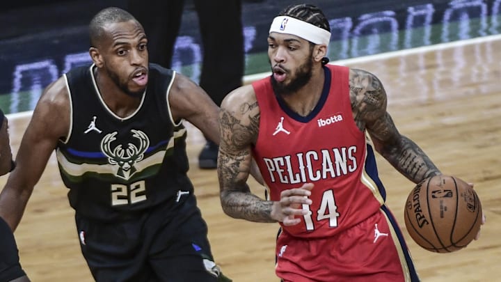 Feb 25, 2021; Milwaukee, Wisconsin, USA;  New Orleans Pelicans forward Brandon Ingram (14) drives to the basket against Milwaukee Bucks forward Khris Middleton (22) in the first quarter at Fiserv Forum. Mandatory Credit: Benny Sieu-Imagn Images