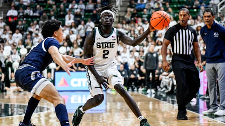 Michigan State's Kur Teng, right, passes the ball against Monmouth during the first half on Monday, Nov. 4, 2024, at the Breslin Center in East Lansing.